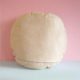 Back of animal cushion. It's stone coloured with a zip at the bottom.